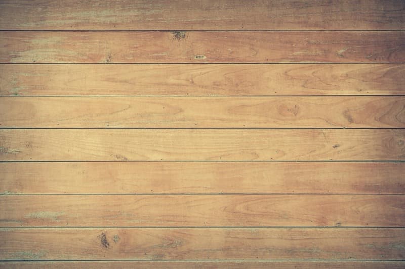 LVP flooring plank next to hardwood flooring plank showing texture comparison