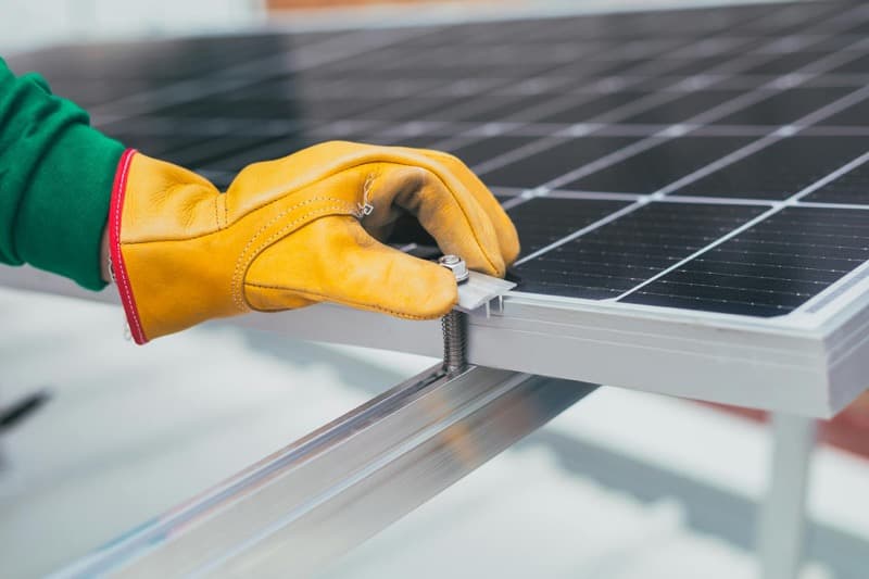 home battery storage unit installed in a garage next to solar inverter
