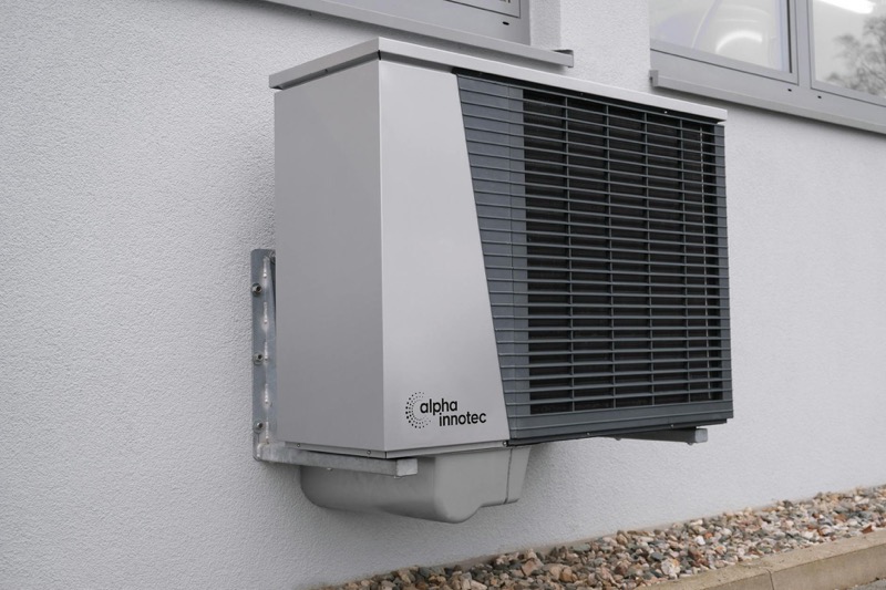 Heat pump outdoor unit installed beside home
