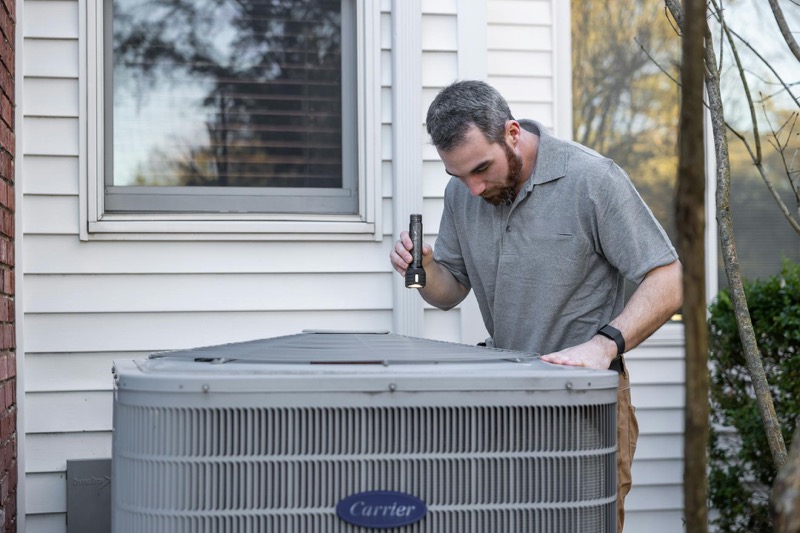 HVAC technician performing annual maintenance inspection